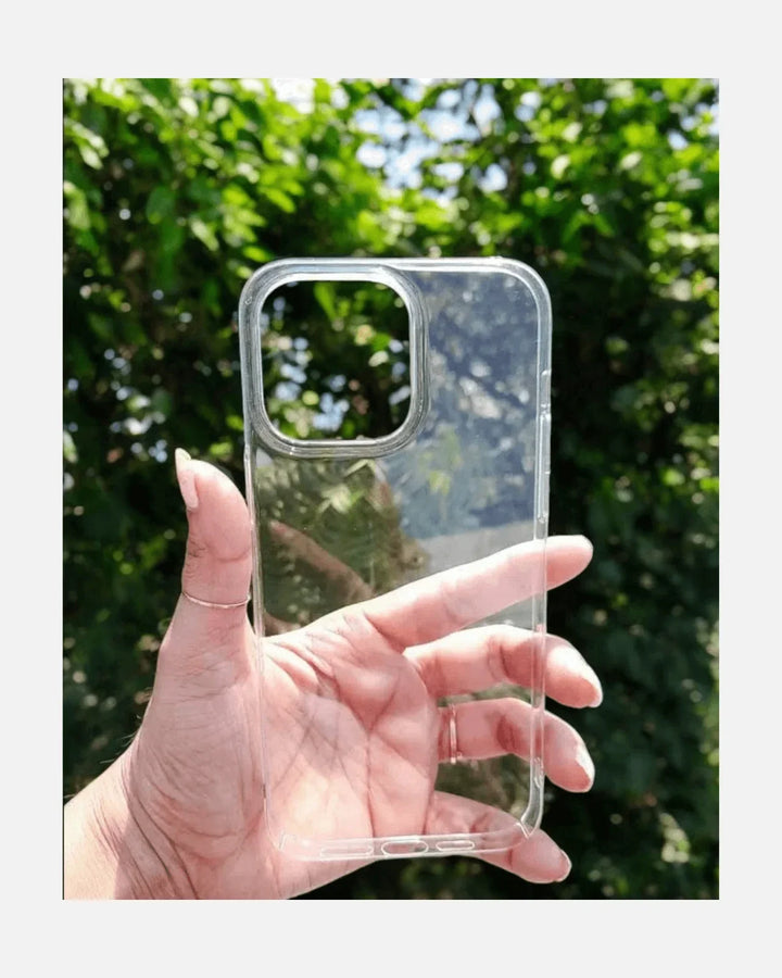 Hand holding an ultra slim transparent iPhone case with a clear back against a green background.