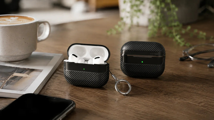 Creslia carbon fiber AirPods Pro case with keychain on marble surface — gym-ready durable design with secure clip