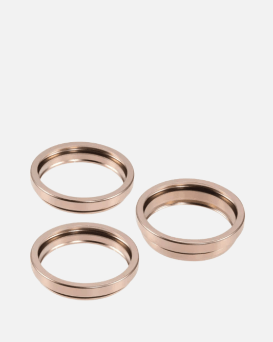Set of three Desert Titanium camera bezel rings for iPhone 16 Pro and Pro Max in sleek design.