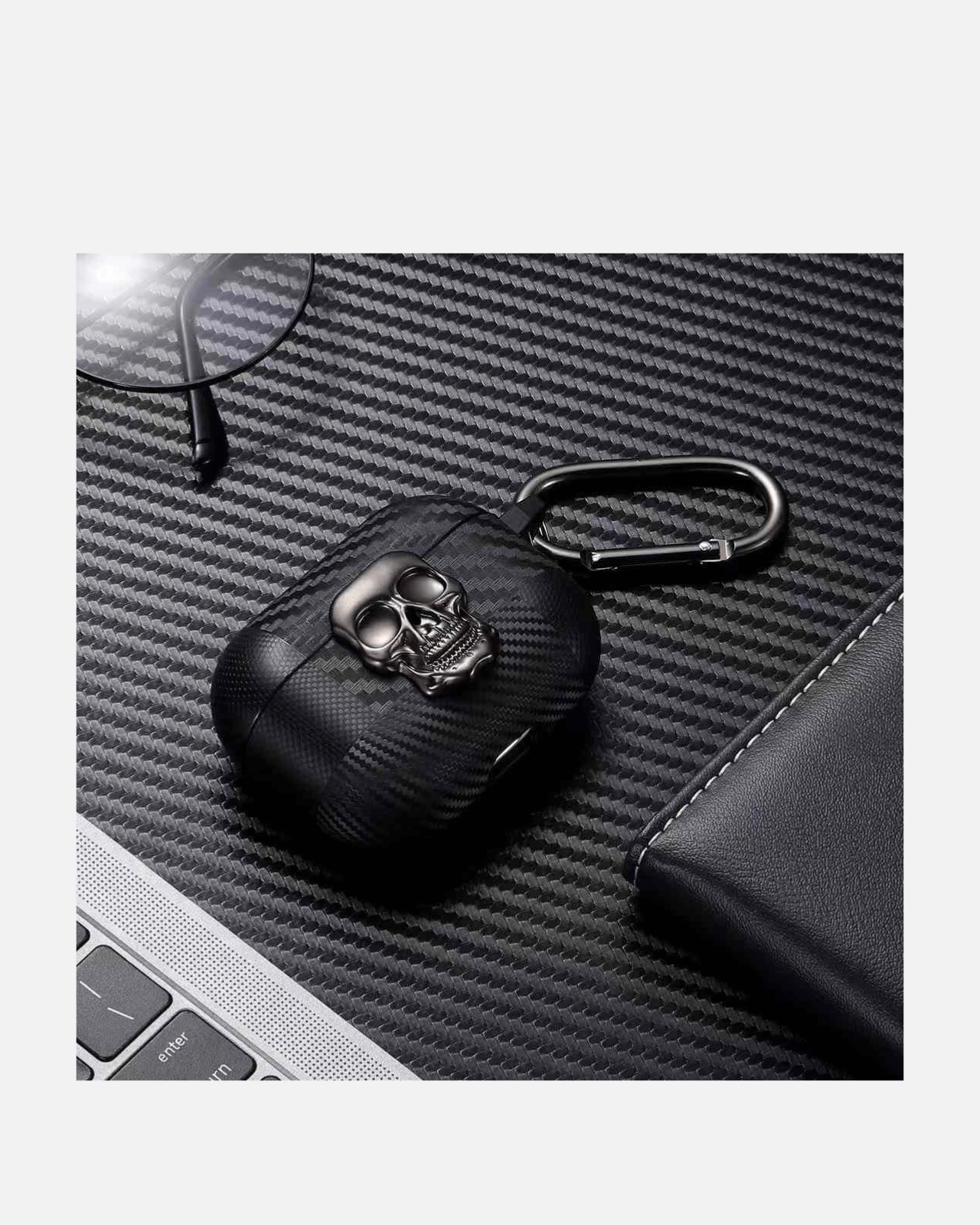 Carbon Skull AirPods case with 3D skull design on a textured surface, showcasing rugged style and durability.