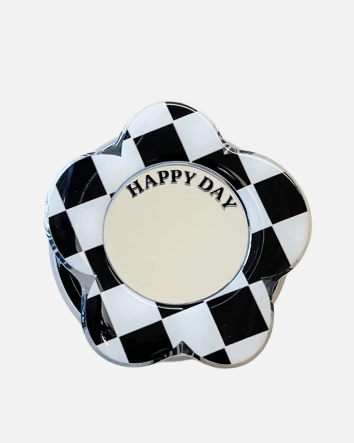 MagSocket PopGrip in Checkers Black – flower-shaped design with a mirror and 'HAPPY DAY' inscription.