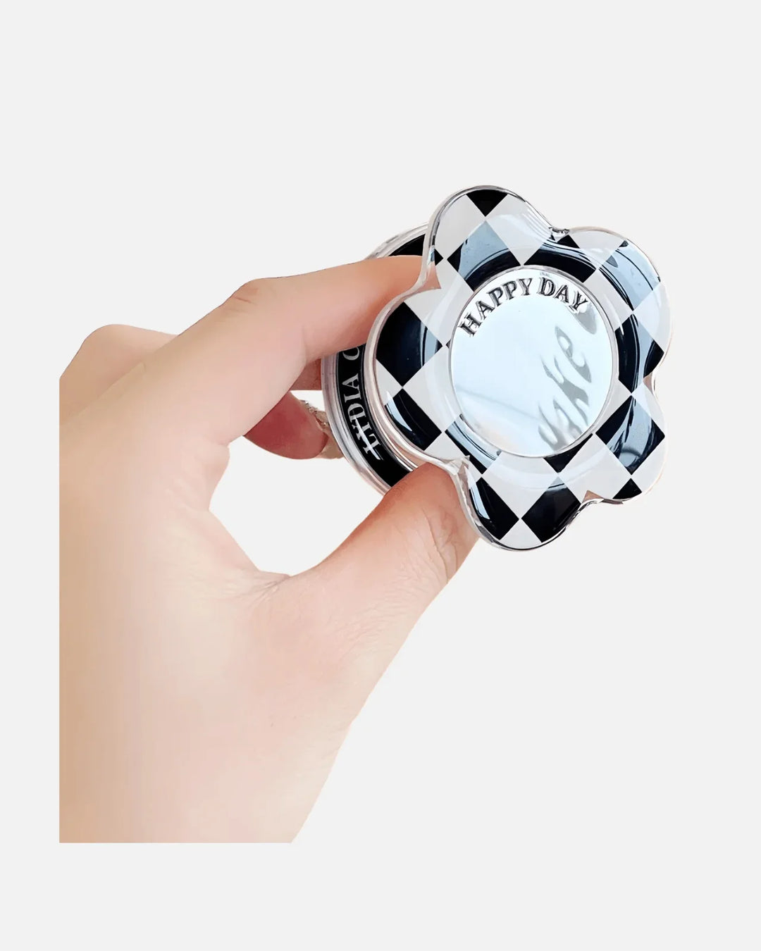 Close-up of MagSocket PopGrip in Checkers Black with built-in mirror and flower shape, held in hand.