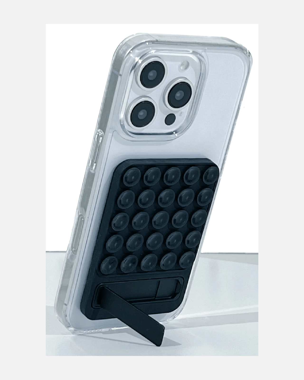 Close-up of Octogrip Silicone Suction Phone Mount on a clear phone case, featuring suction cups and a foldable kickstand.