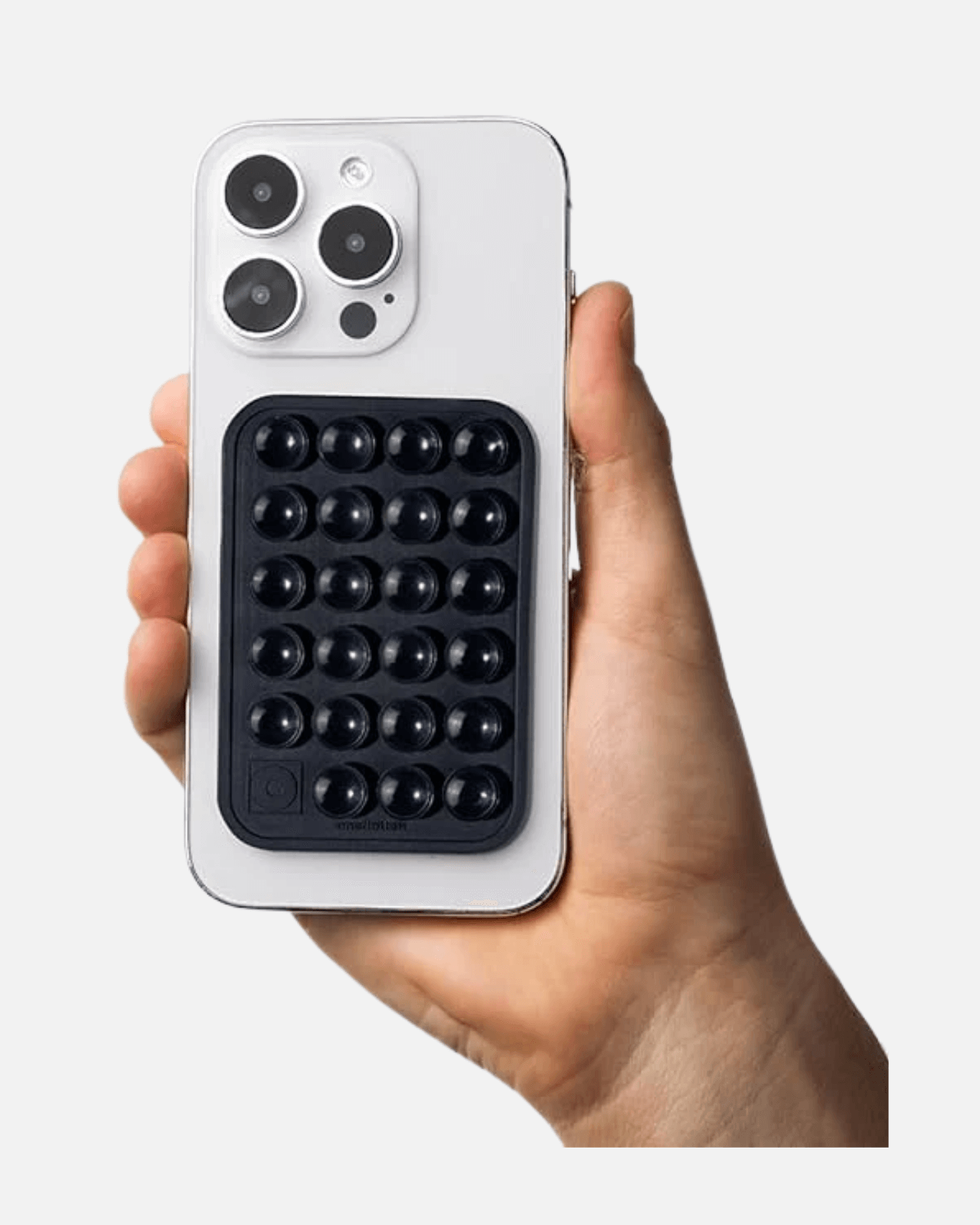 Octogrip Silicone Suction Phone Mount on a white smartphone held in hand for hands-free convenience.