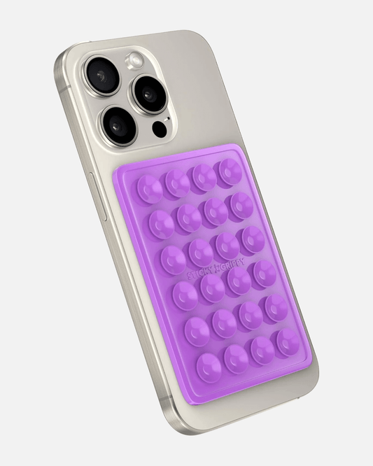 Octogrip Silicone Suction Phone Mount in purple, securely attaching to a smartphone for hands-free use.