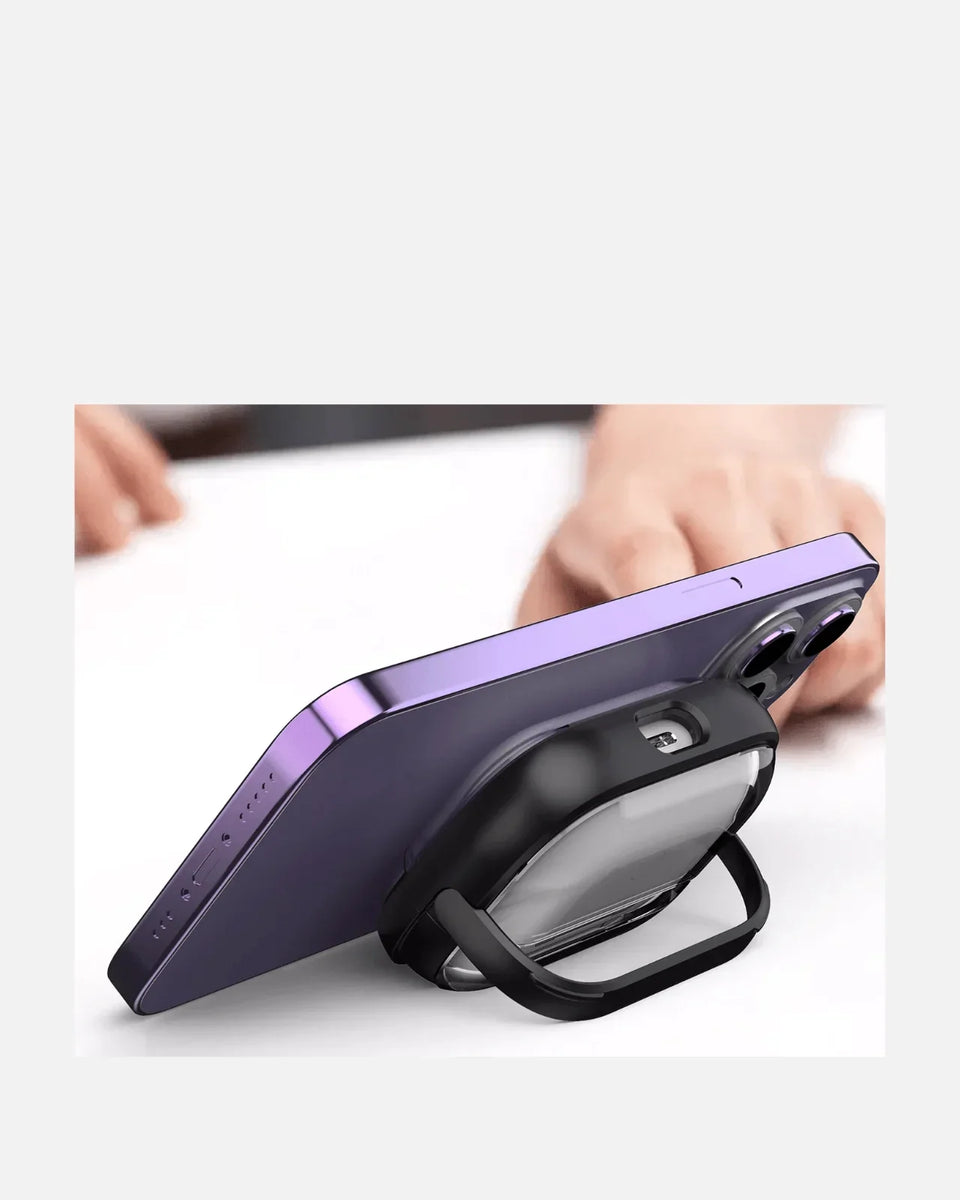 Transparent Shockproof AirPods case with kickstand supporting a smartphone on a table, showcasing versatility.